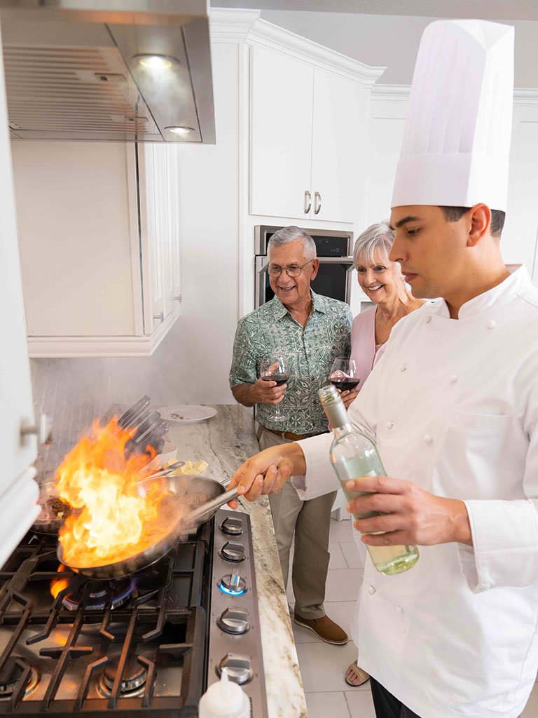 Couple watching an expert chef cook during an in-home Chef Experience