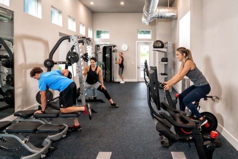 People working out with exercise equipment in the Rentyl at Reunion fitness center