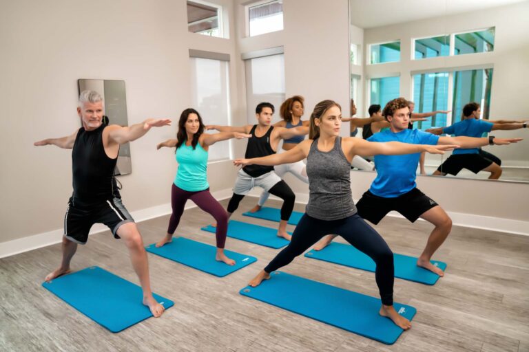 Group doing yoga exercises in the Rentyl at Reunion clubhouse