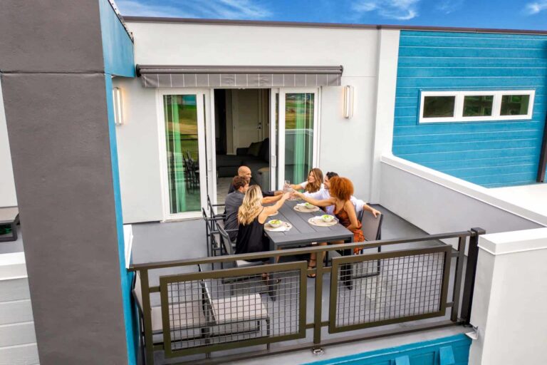 Group dining together on a Rentyl at Reunion condo outdoor terrace