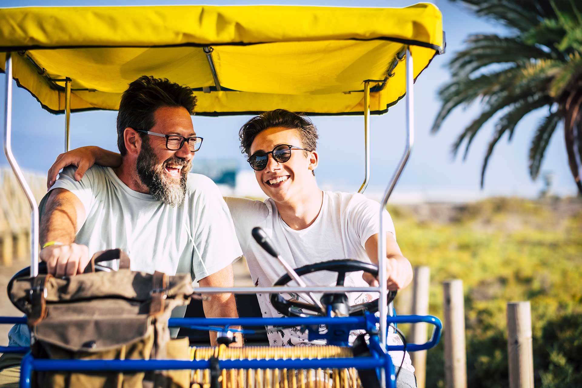 Father and son riding in a surrey bike on Rentyl at Reunion’s walking bike trails