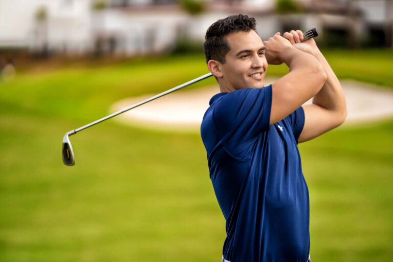 Man Swinging A Golf Club On The Jack Nicklaus Golf Course At Bear's Den Resort In Florida.